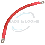 Red insulated automotive battery cable with crimped ring terminals, heavy-duty positive power lead for high-current electrical systems